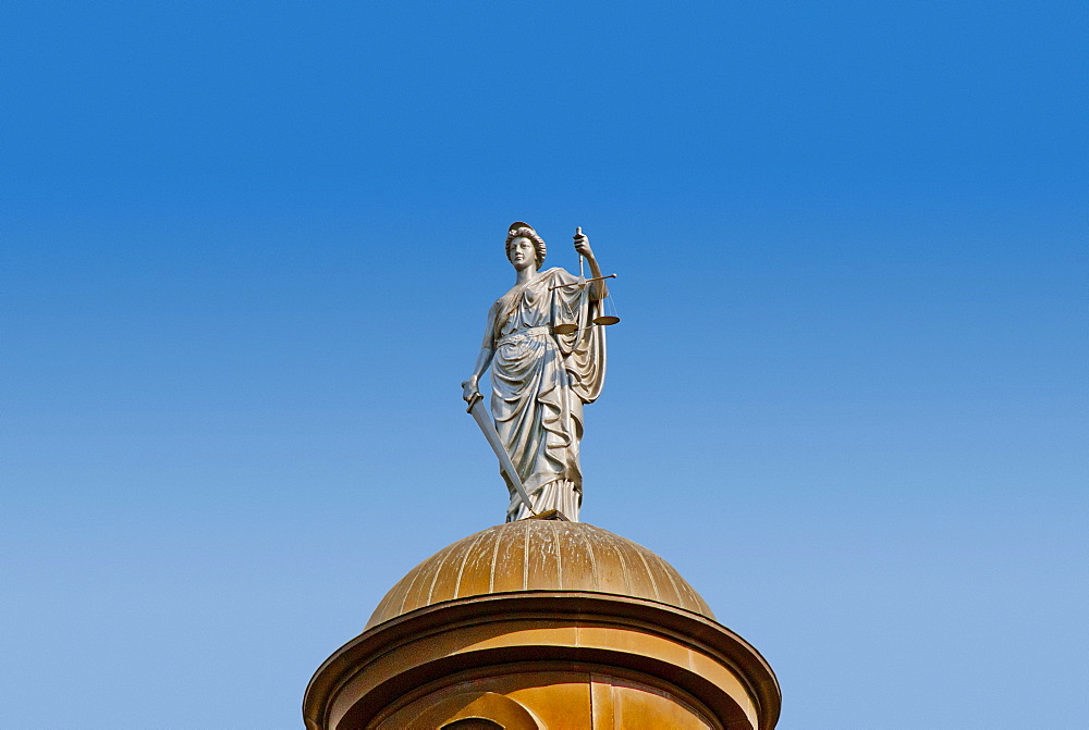 USA, Texas, San Marcos, Statue of Justice on top of copper dome of 1908 Hays County Courthouse