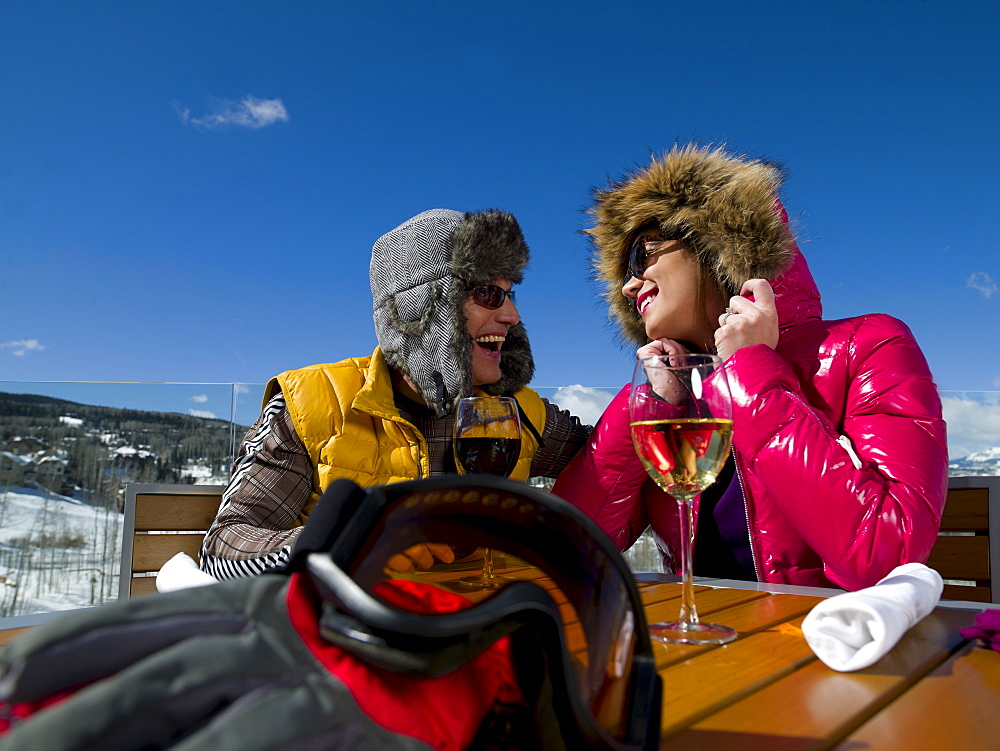 USA, Colorado, Telluride, Couple enjoying outdoor meal at ski resort