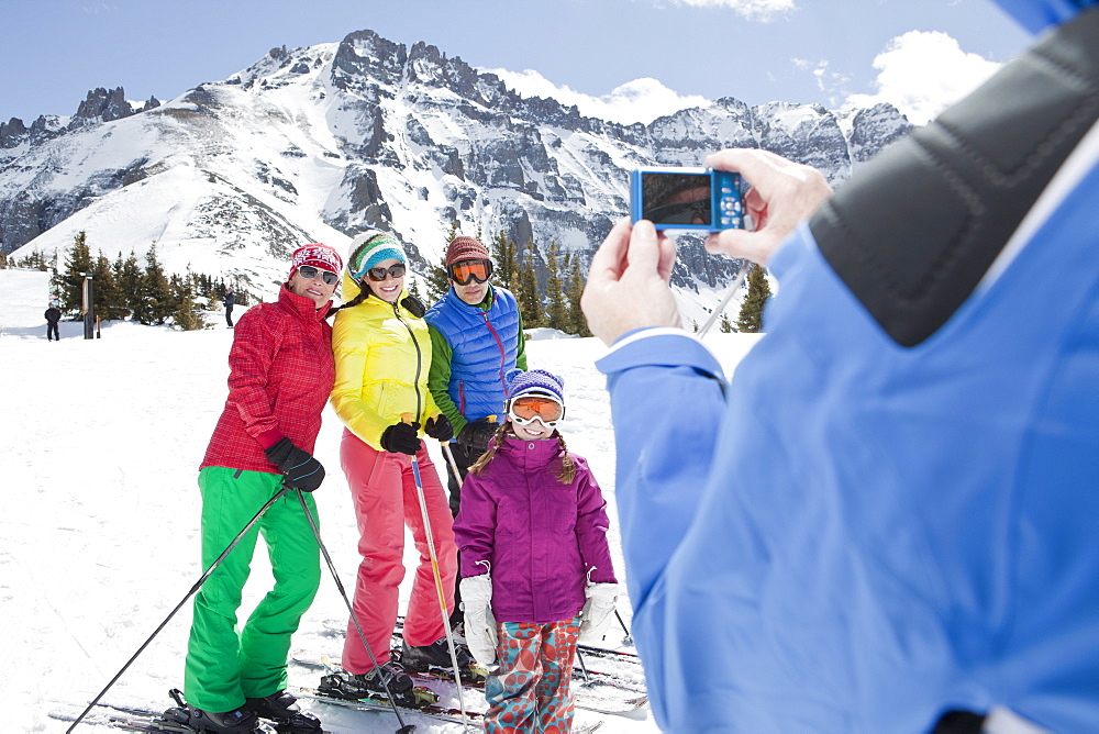 USA, Colorado, Telluride, Three-generation family with girl (10-11) posing during ski holiday