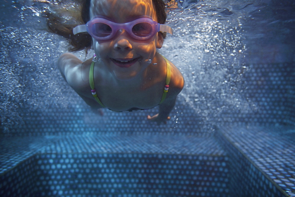 Portrait of girl (4-5) swimming underwater