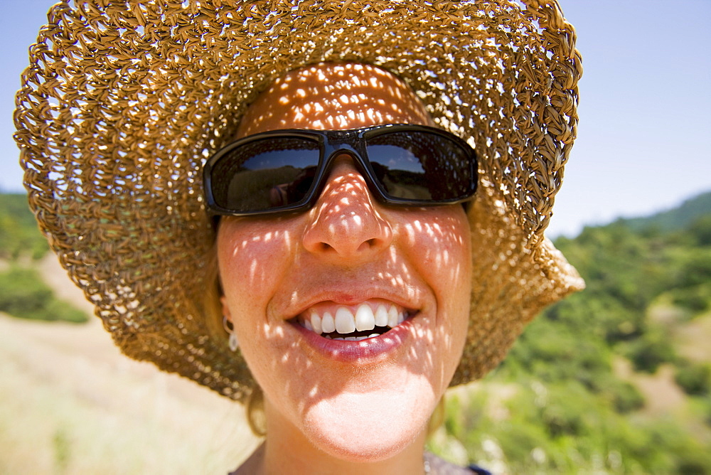 USA, California, Woman wearing straw hat