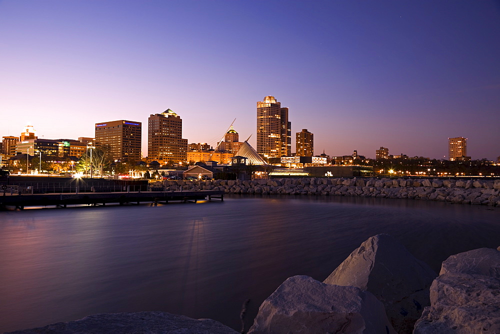 USA, Wisconsin, Milwaukee skyline across lake at dusk