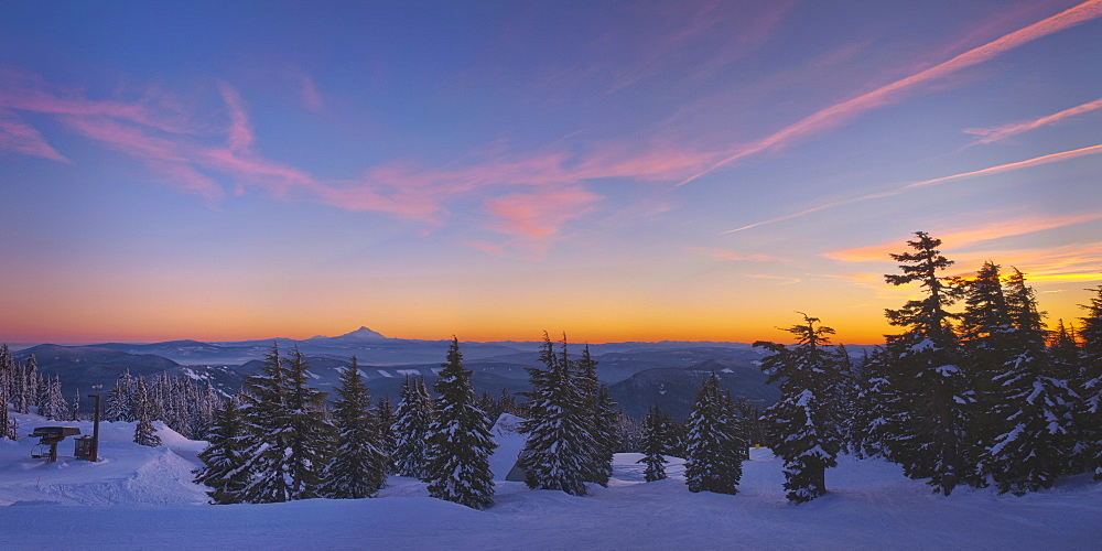 USA, Oregon, Snow covered field with Mount Jefferson in background, sunset