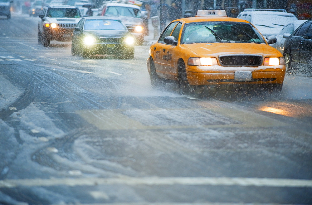 USA, New York, New York City, Traffic on street in snow