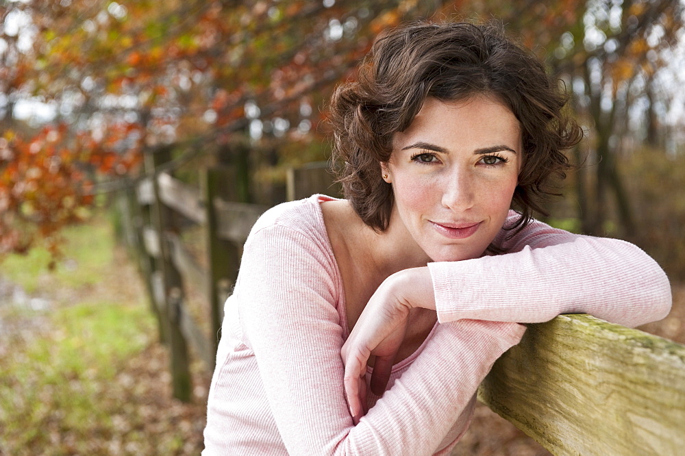 Woman leaning on fence