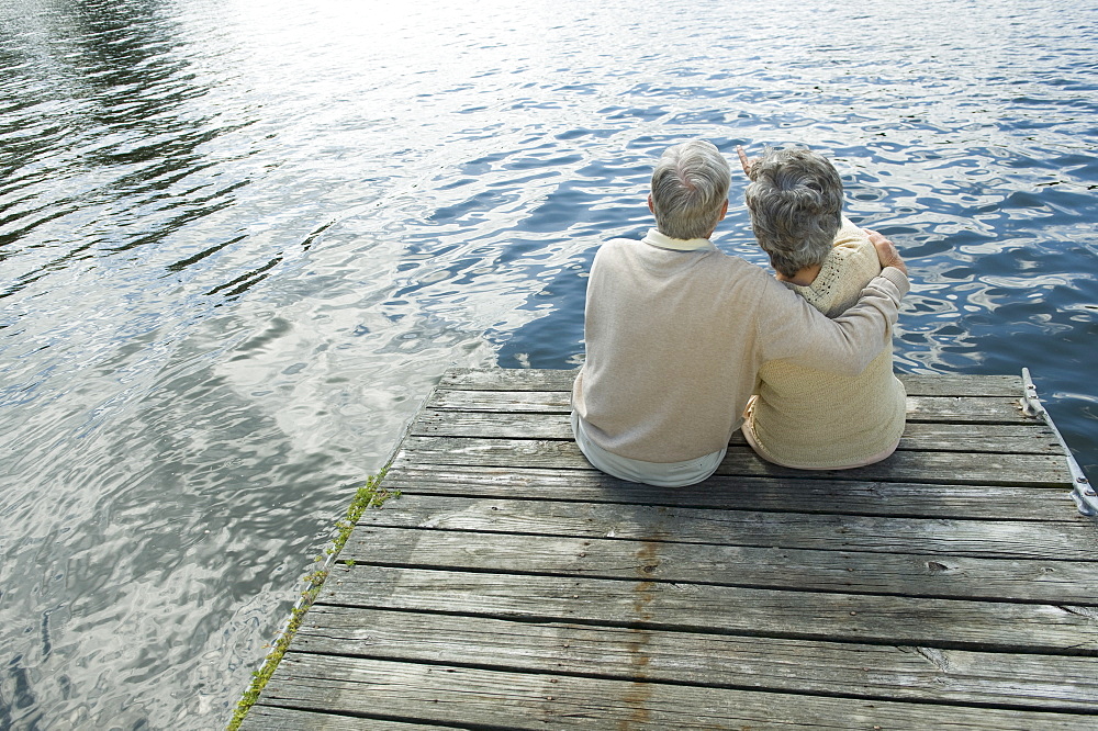 Senior couple hugging on dock