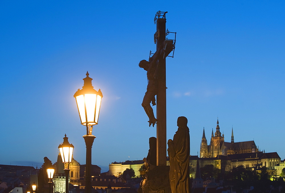 Night view of crucifix and cathedral