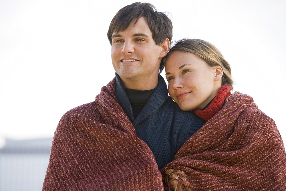 Couple wrapped in blanket