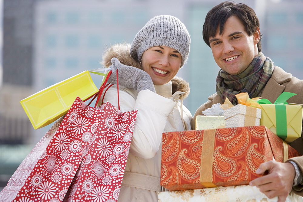 Couple carrying shopping bags and gifts