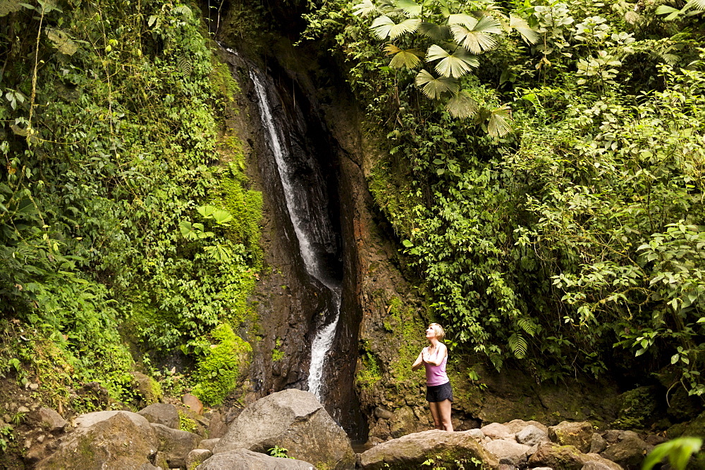 Woman under waterfall, Costa Rica