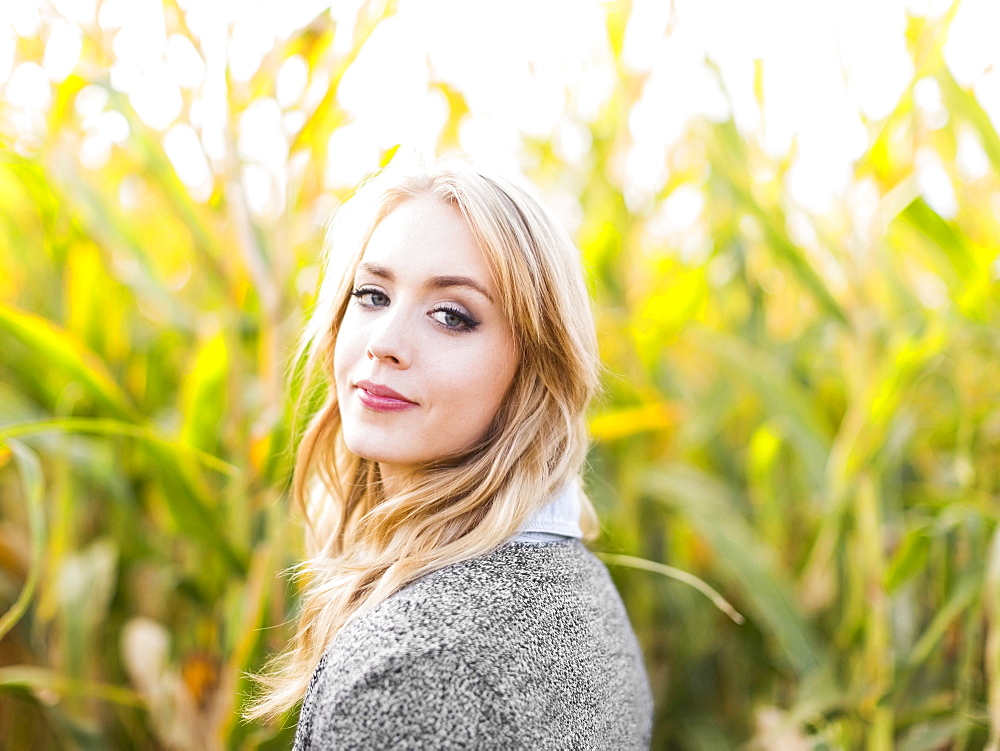 Portrait of young woman in corn field