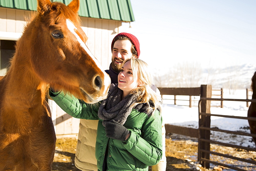 Young couple stroking horse, Salt Lake City, Utah