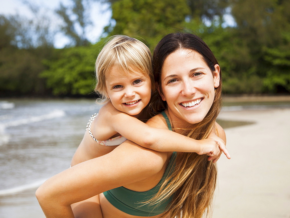 Mother with daughter (2-3) on beach, Kauai, Hawaii