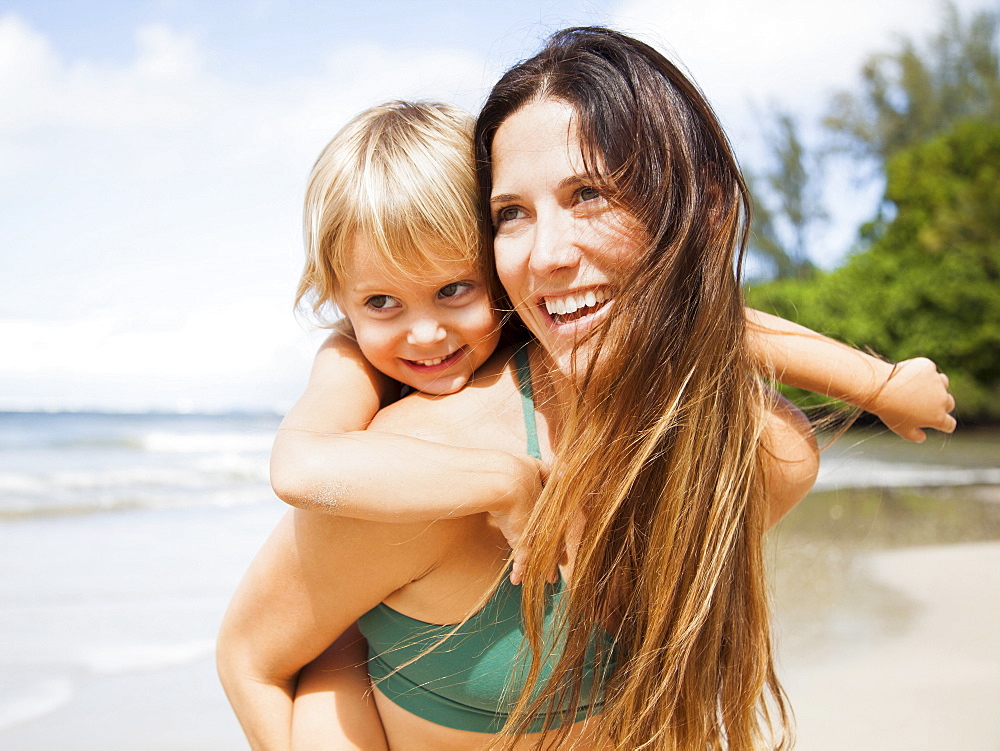 Mother with daughter (2-3) on beach, Kauai, Hawaii