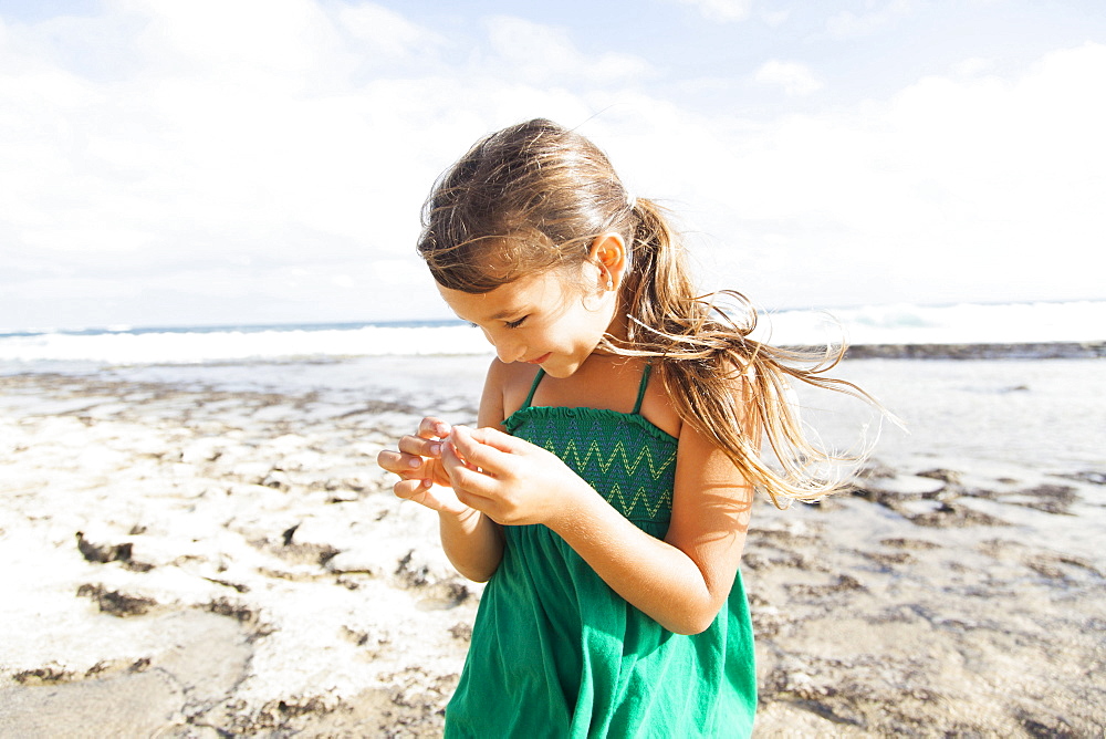 Girl (6-7) playing on beach, Kauai, Hawaii