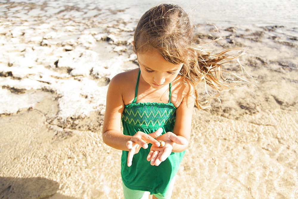 Girl (6-7) playing on beach, Kauai, Hawaii