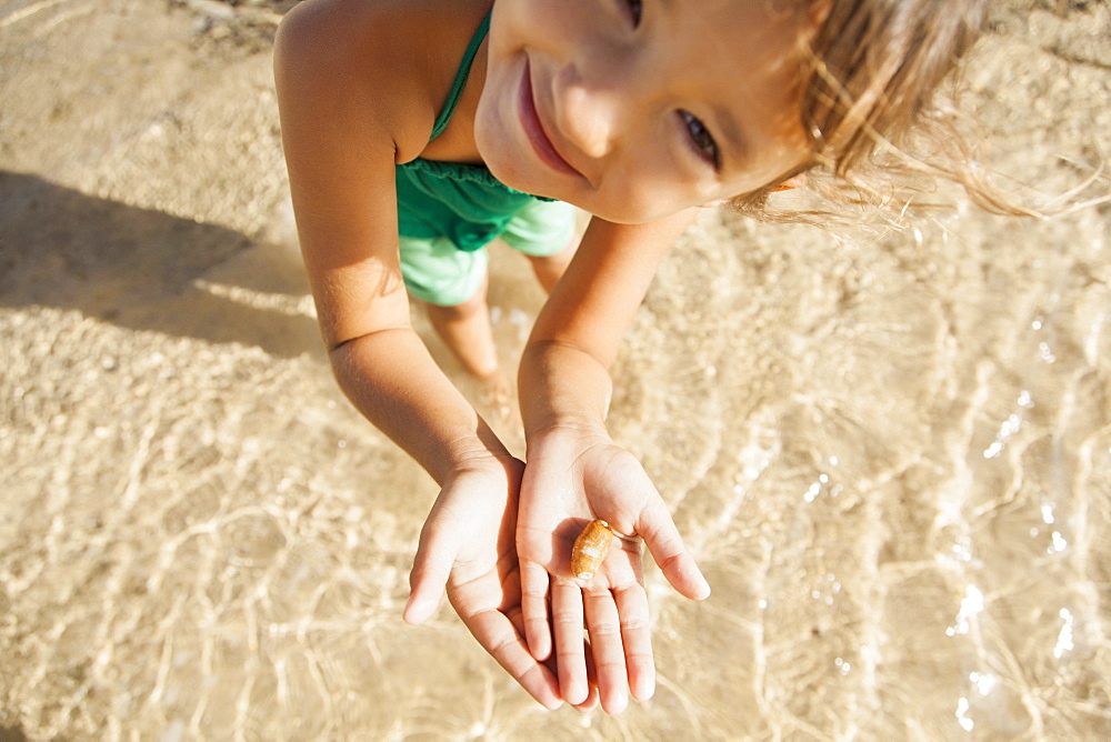 Girl (6-7) playing on beach, Kauai, Hawaii