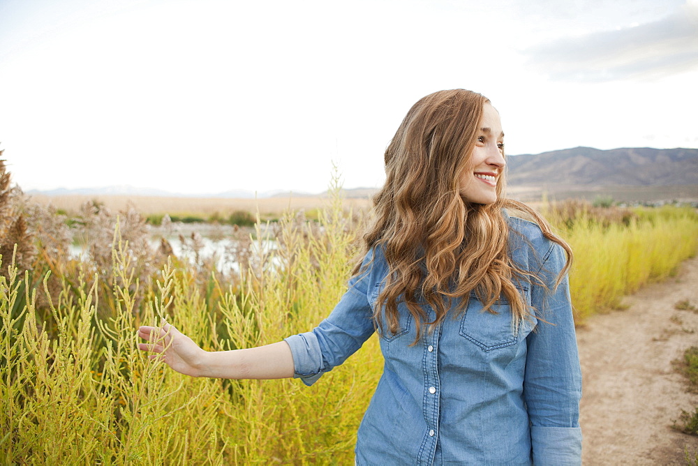 Portrait of young woman on dirt road, Salt Lake City, Utah