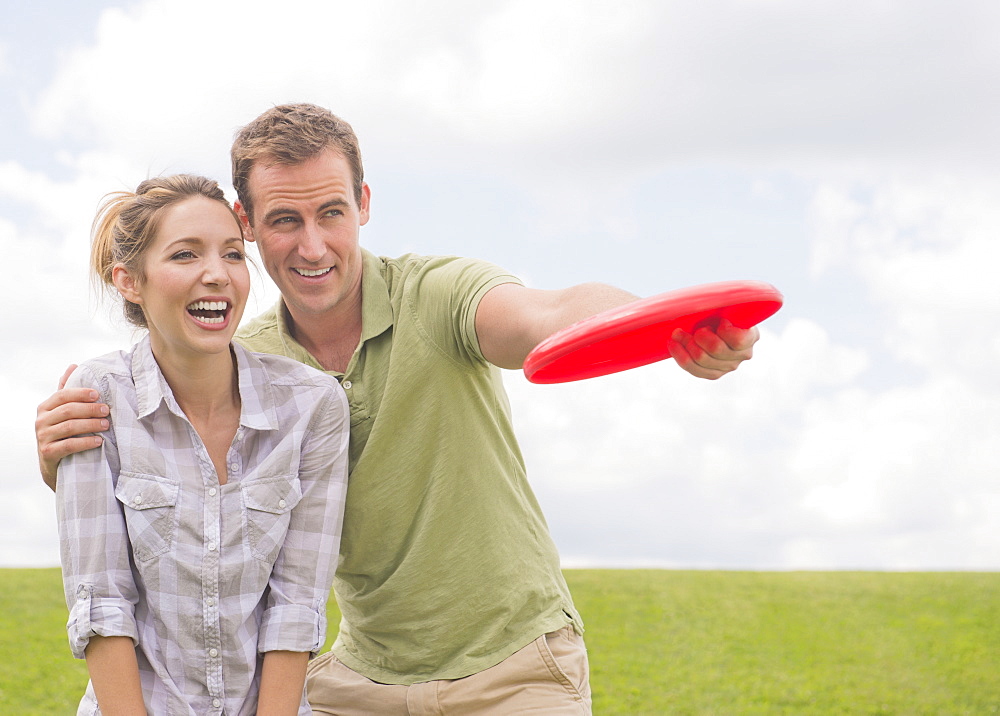 Couple playing with frisbee, USA, New Jersey, Mendham