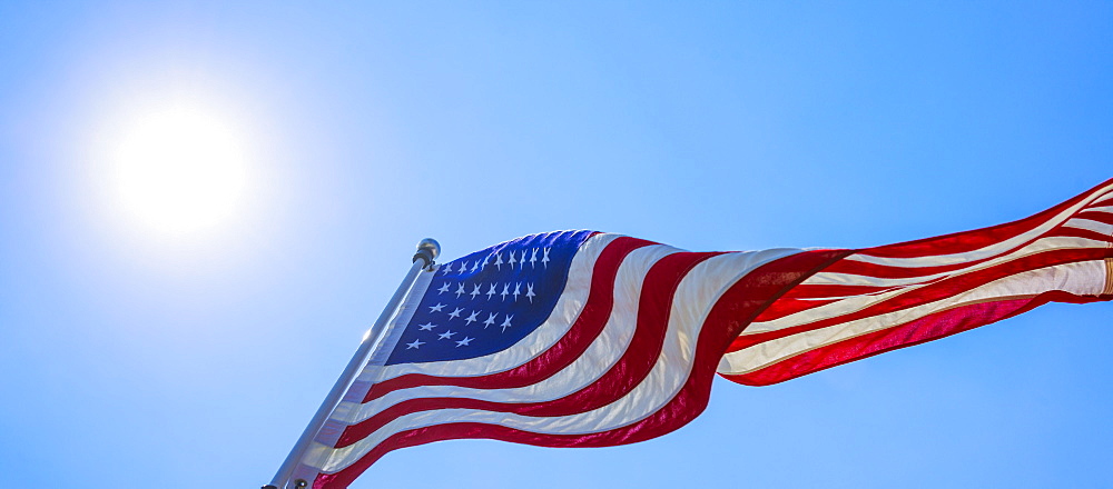US flag against blue sky