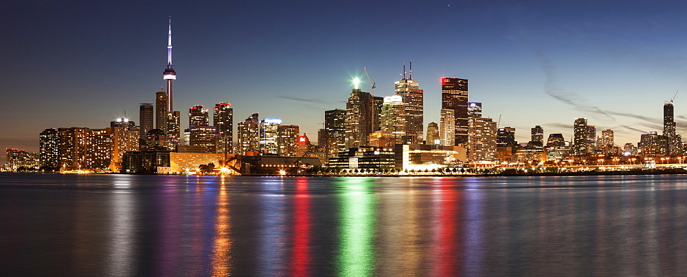 Illuminated waterfront skyline reflecting in Lake Ontario, Toronto, Canada