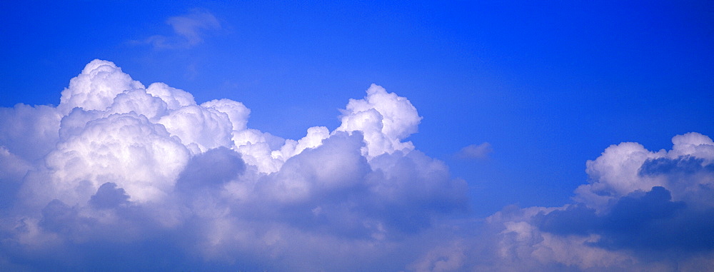 Puffy clouds and blue sky