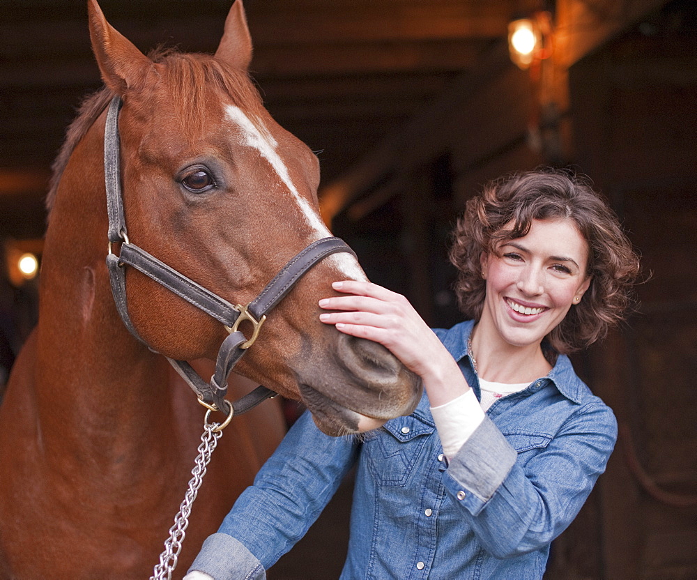 Woman holding horse