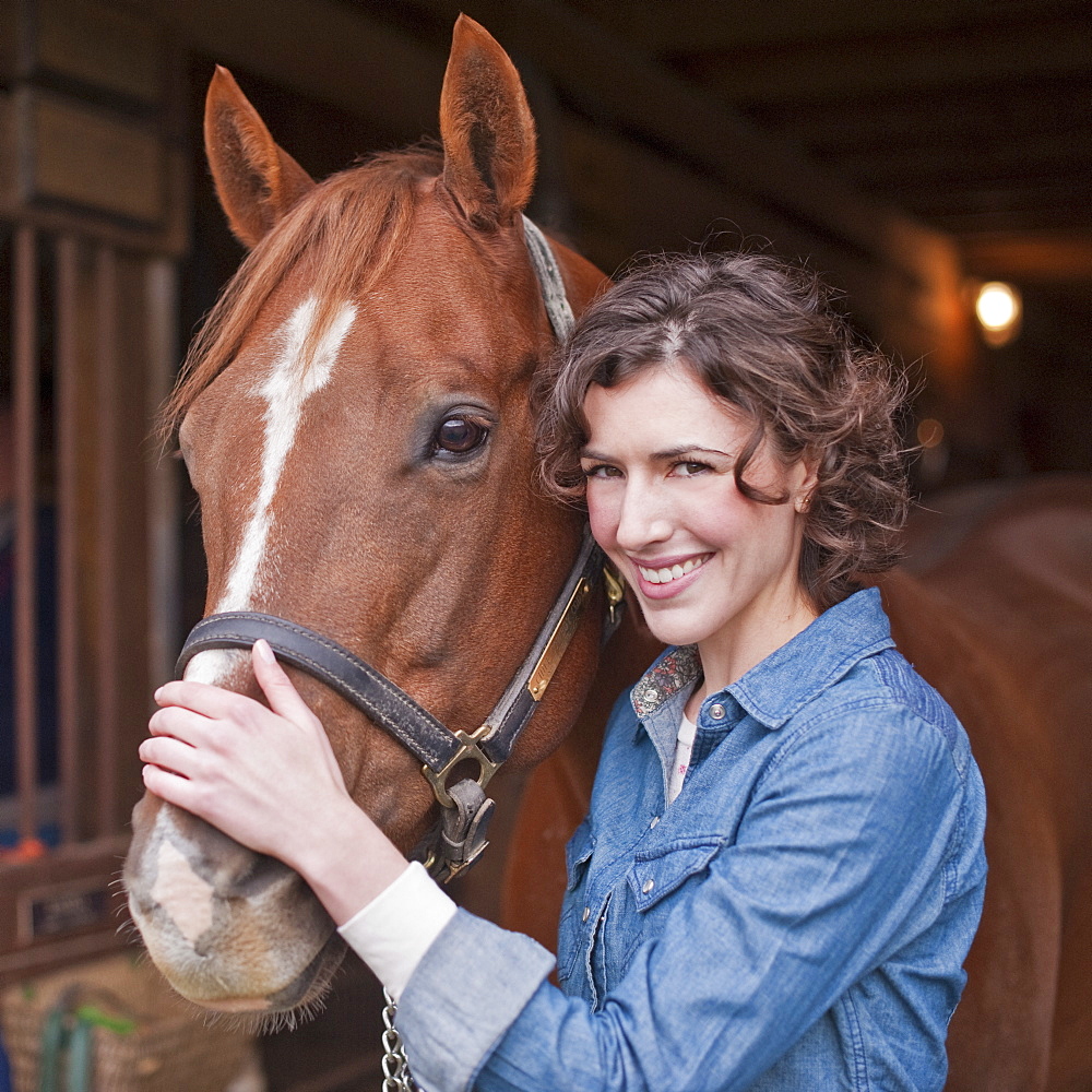 Woman holding horse