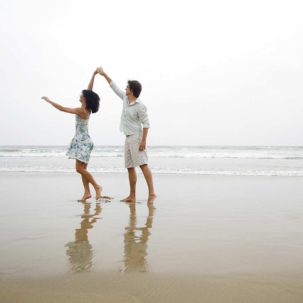 Couple dancing on beach