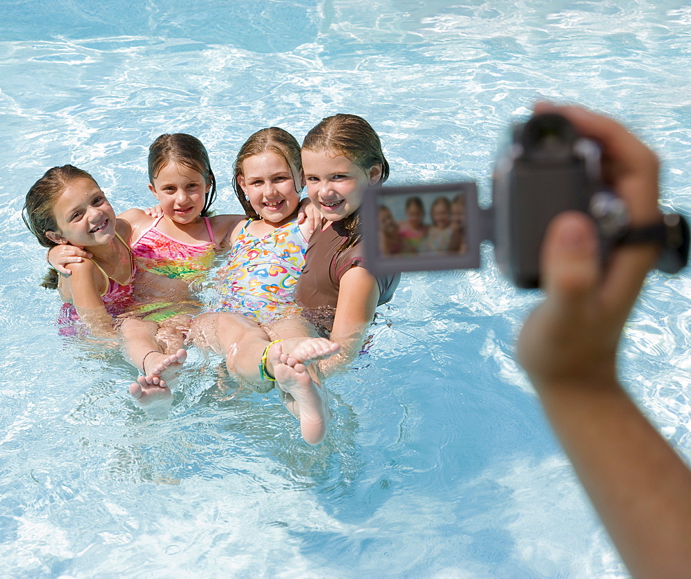 Girls being videotaped in swimming pool