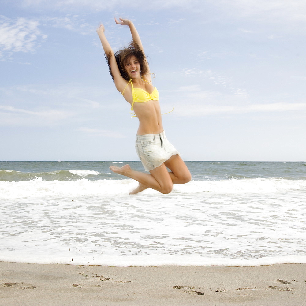 Woman jumping at beach