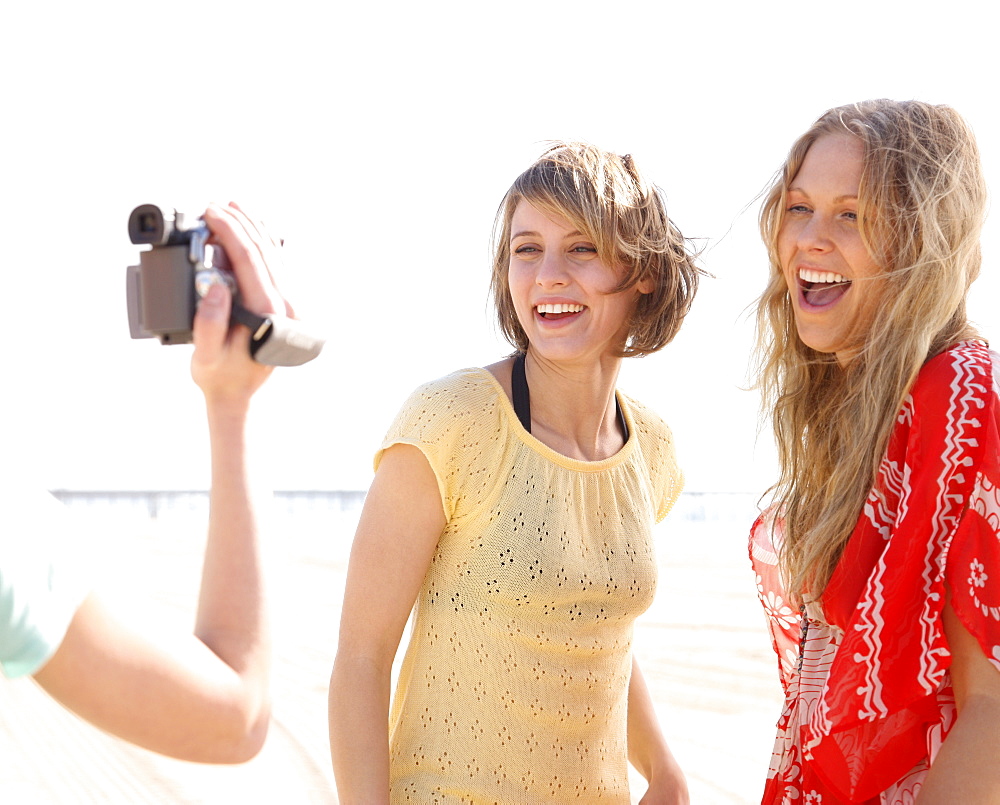 Women being filmed on beach