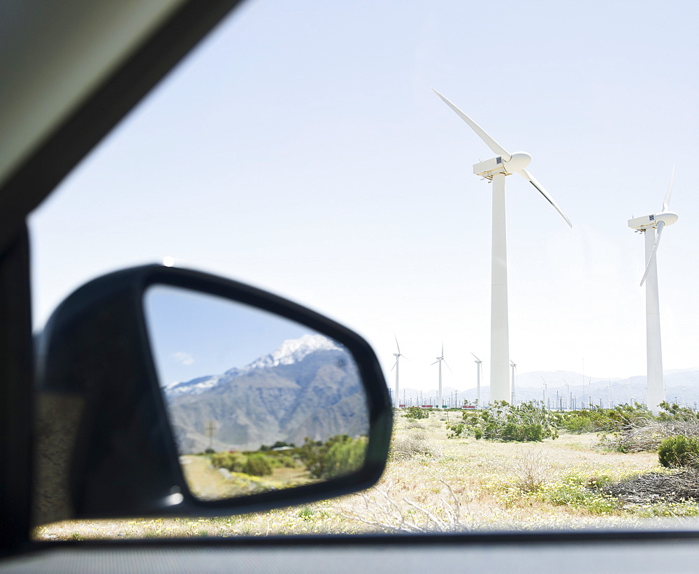 USA, California, Palm Springs, Coachella Valley, San Gorgonio Pass, Mountains reflecting in rear- view mirror with wind turbines in background