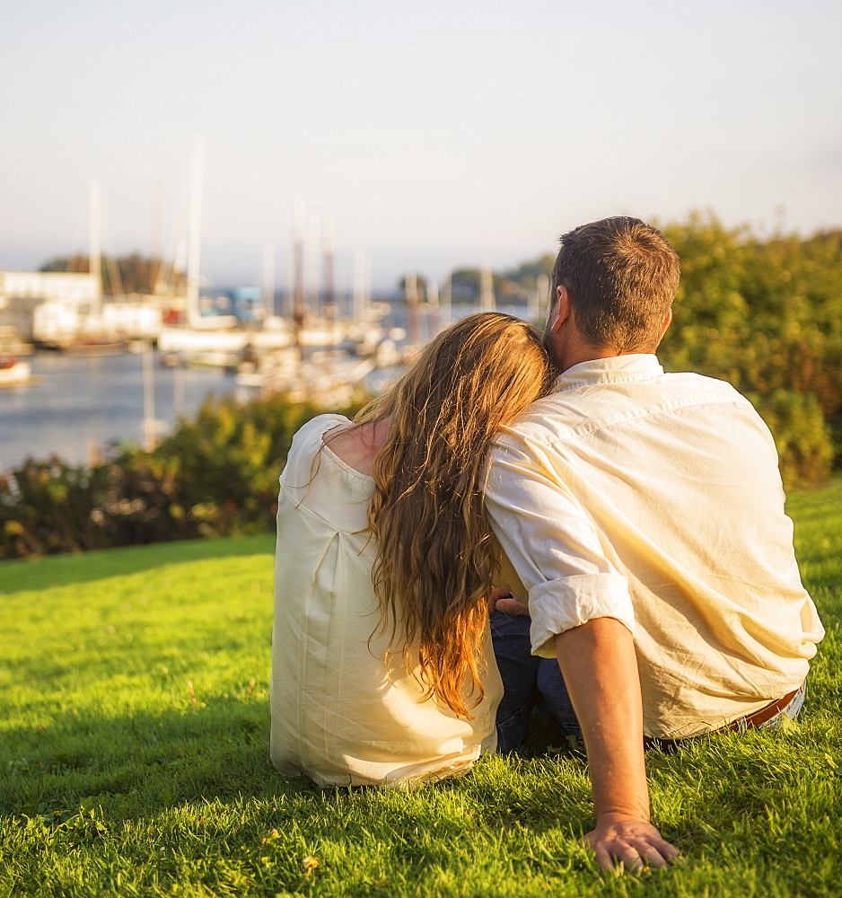 Back view of couple looking at harbor, Camden, Maine