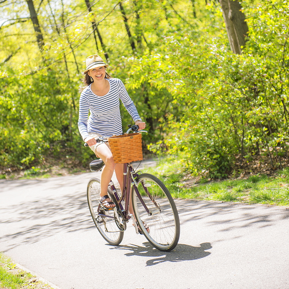 Mid adult woman riding bicycle, Central Park, New York City