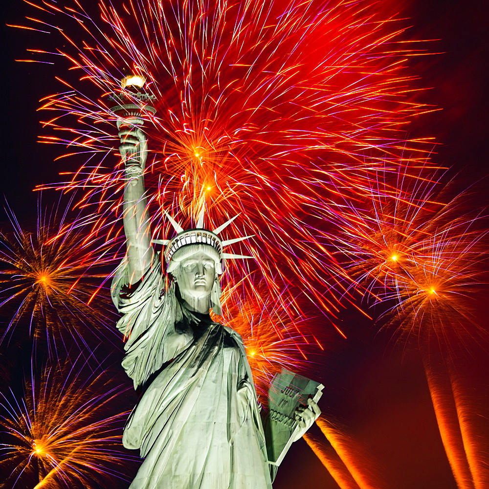 Firework display behind Statue of Liberty