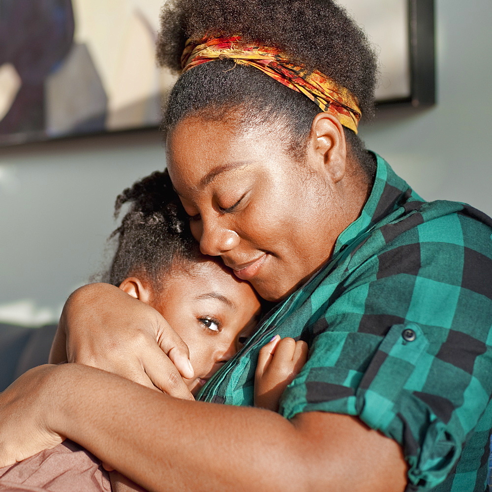 African American mother comforting daughter