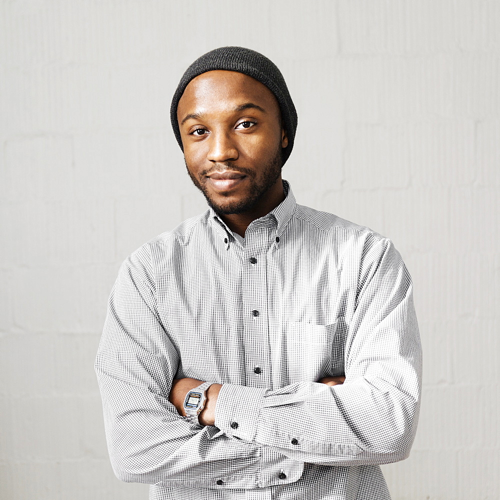 Close up portrait of smiling Black man wearing stocking-cap