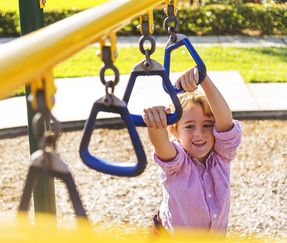 Boy (8-9) playing on playground, Jupiter, Florida, USA