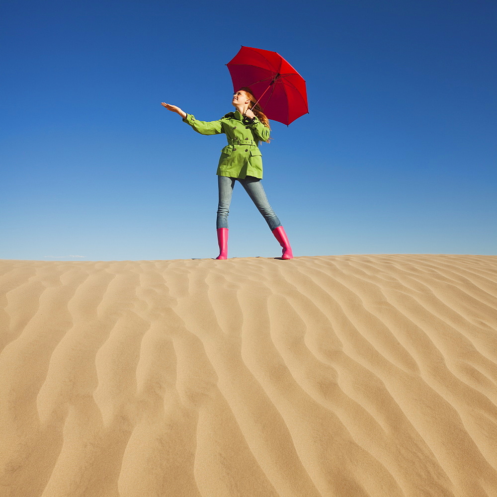 Woman waiting for rain in the desert