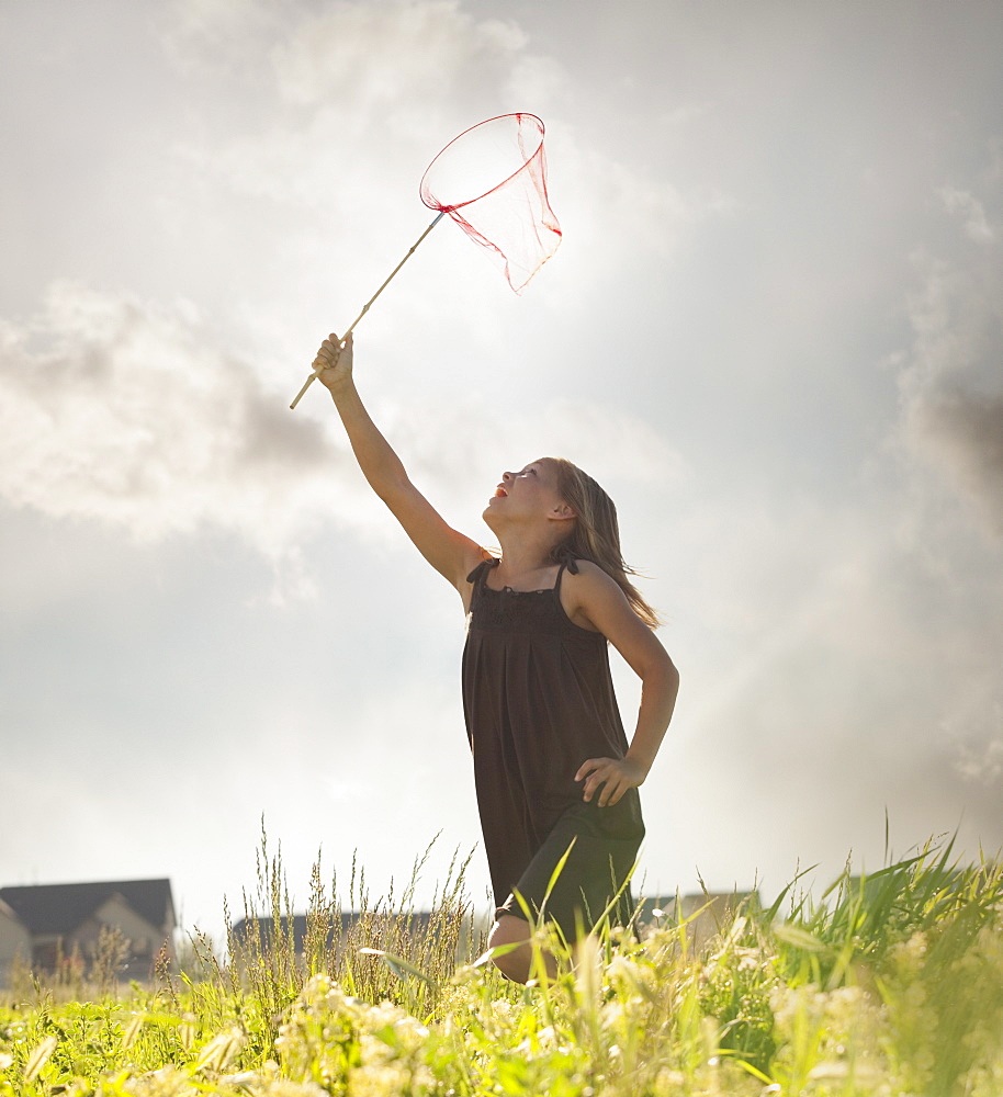 Young girl running with a butterfly net