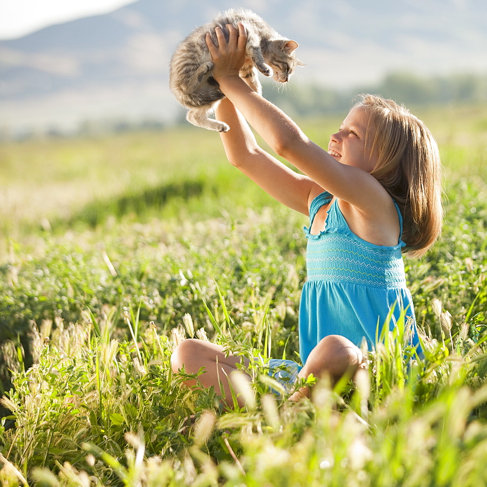 Young girl holding a kitten