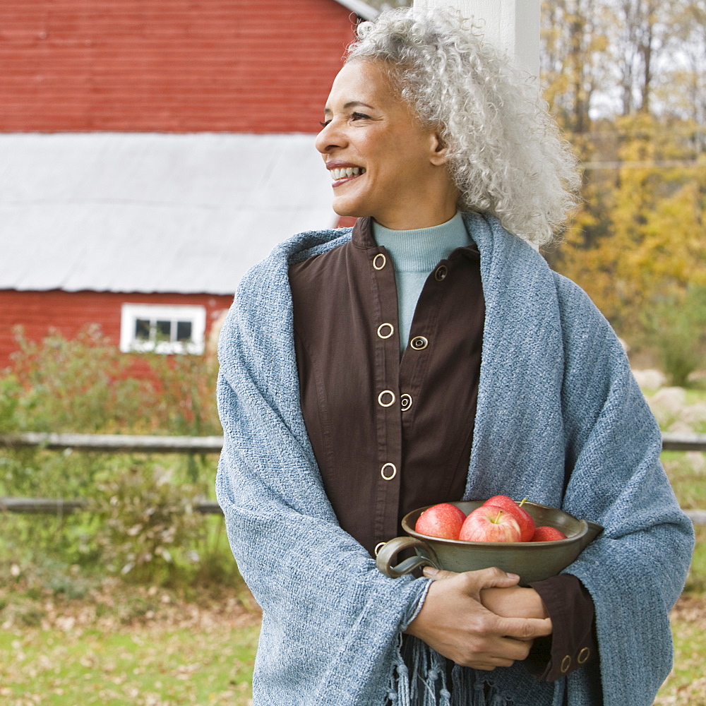 Woman holding bowl of apples