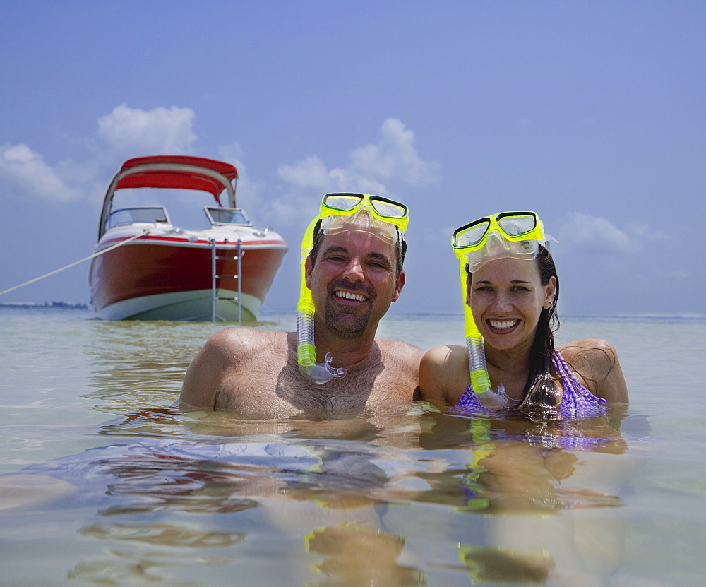 Couple with snorkeling gear in water, Florida, United States