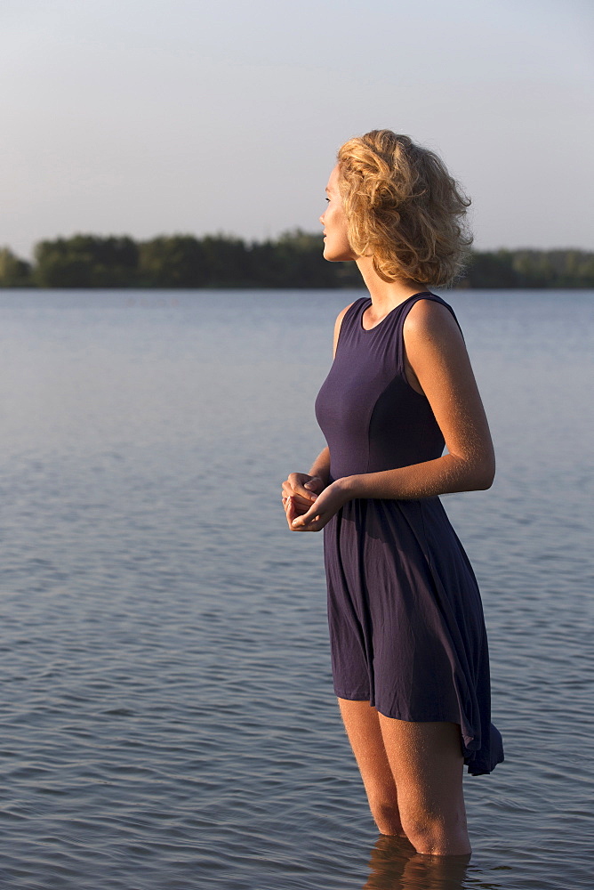 Beautiful woman standing in lake, Netherlands, Gelderland, De Rijkerswoerdse Plassen