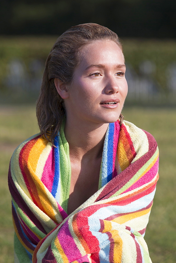 Woman wrapped in stripped towel, Netherlands, Gelderland, De Rijkerswoerdse Plassen