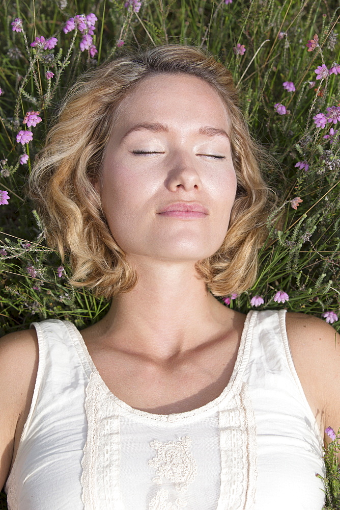 Woman relaxing on meadow