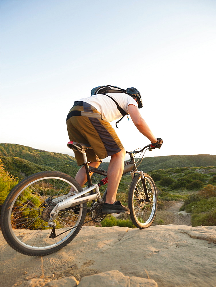 USA, California, Laguna Beach, Man cycling down hill