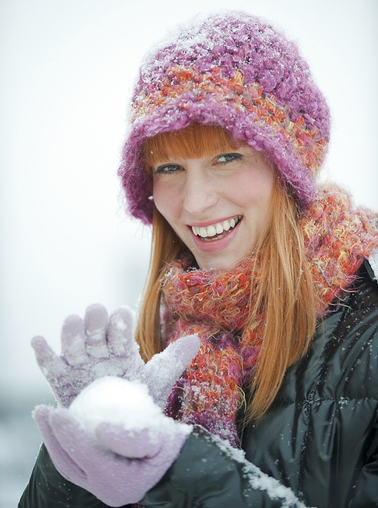 Woman packing snowball
