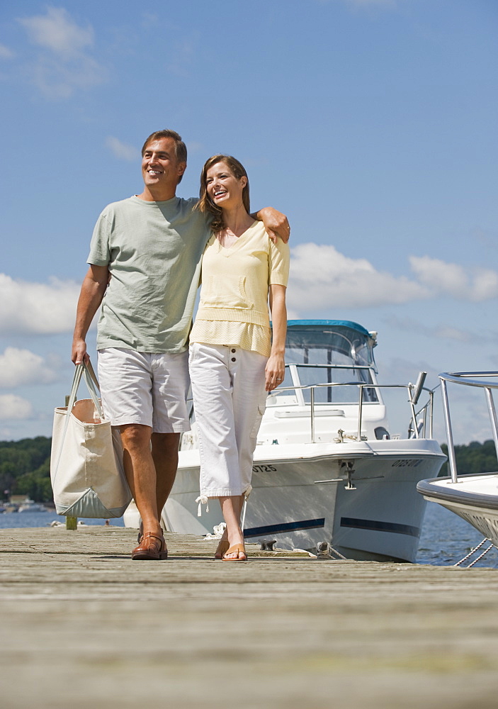 Couple walking on boat dock